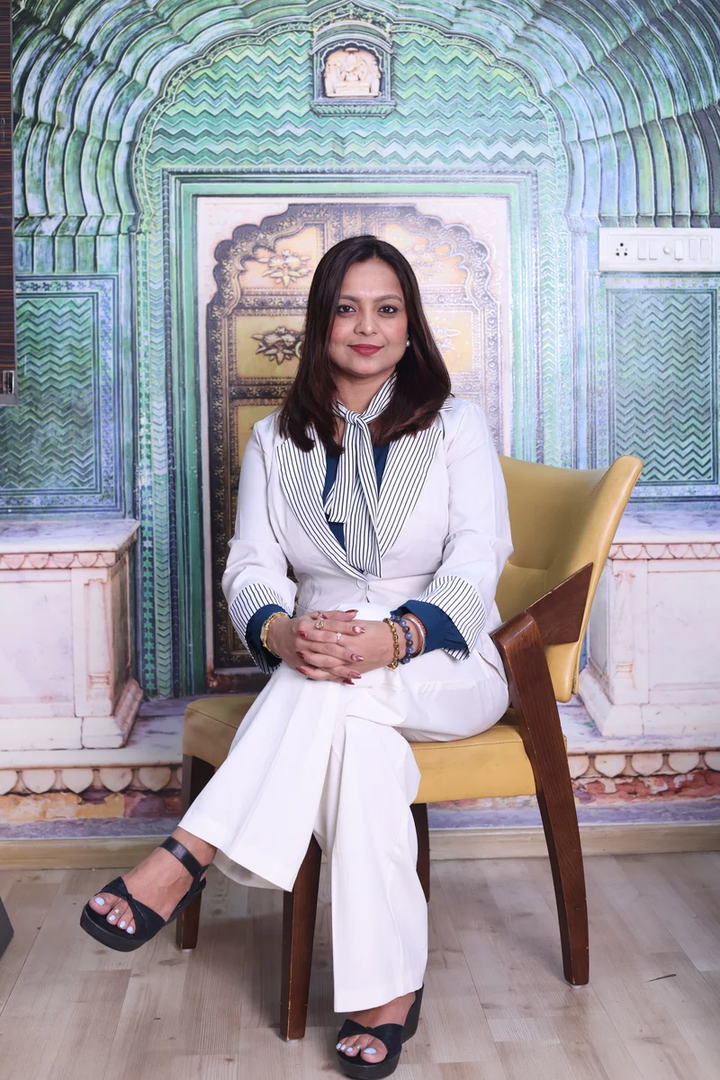 Dr. Shreya Joshi smiling in striped blazer